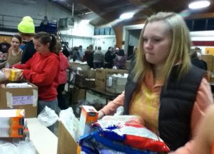 FUN WITH PACKING NHS member Sam Barnum helps pack boxes for families in need at Project Christmas.  NHS members were given the opportunity to volunteer at Project Christmas to complete their 10 hours.  