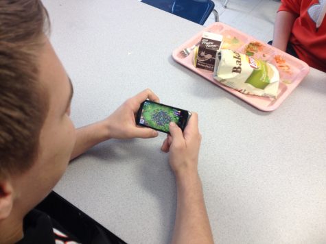 Kyle Peterson plays Clash of Clans during lunch. He is one of many students that takes advantage of this allowed time to play on phones during lunch.