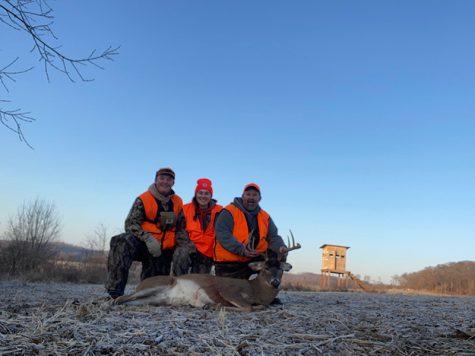 Family poses with deer during gun deer season in Wisconsin