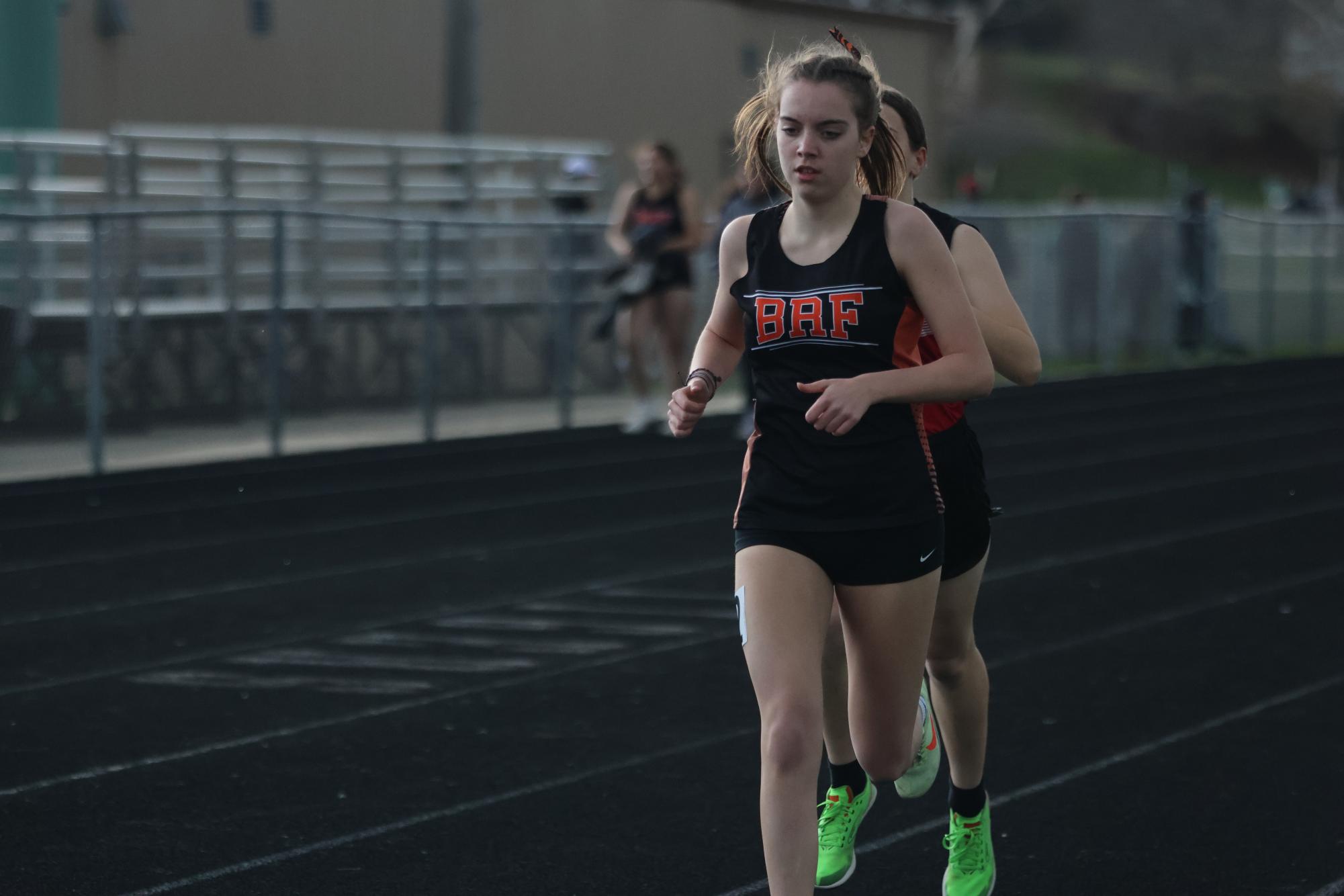 Junior Lillian Miller competing in the 1600 meter despite the sudden rain that came down on the Tigers home meet