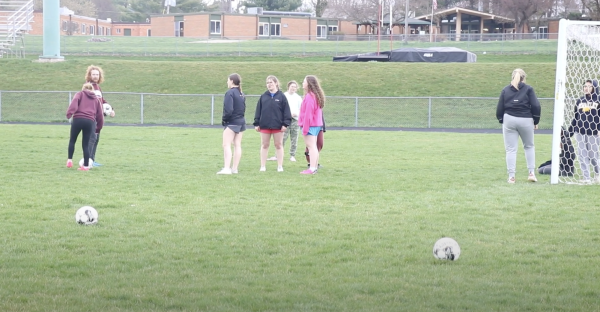 Girls club soccer team anticipates the outcome of their first soccer game