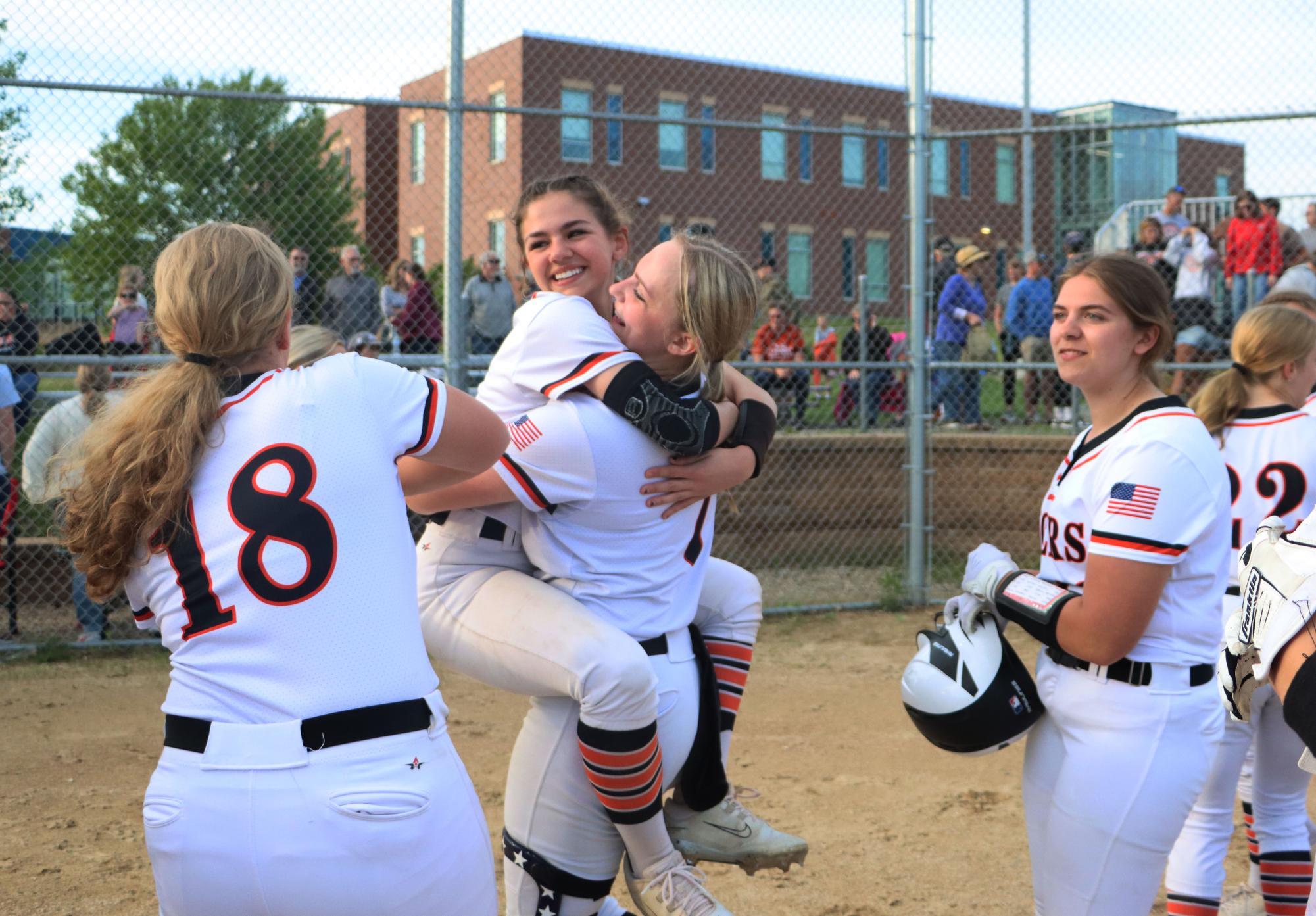 After sophomore Evelyn Bolger hit the game winning ball, sophomore Anna Janowski and senior Madyson Schultz embrace in celebration for the continuation of their season. 
